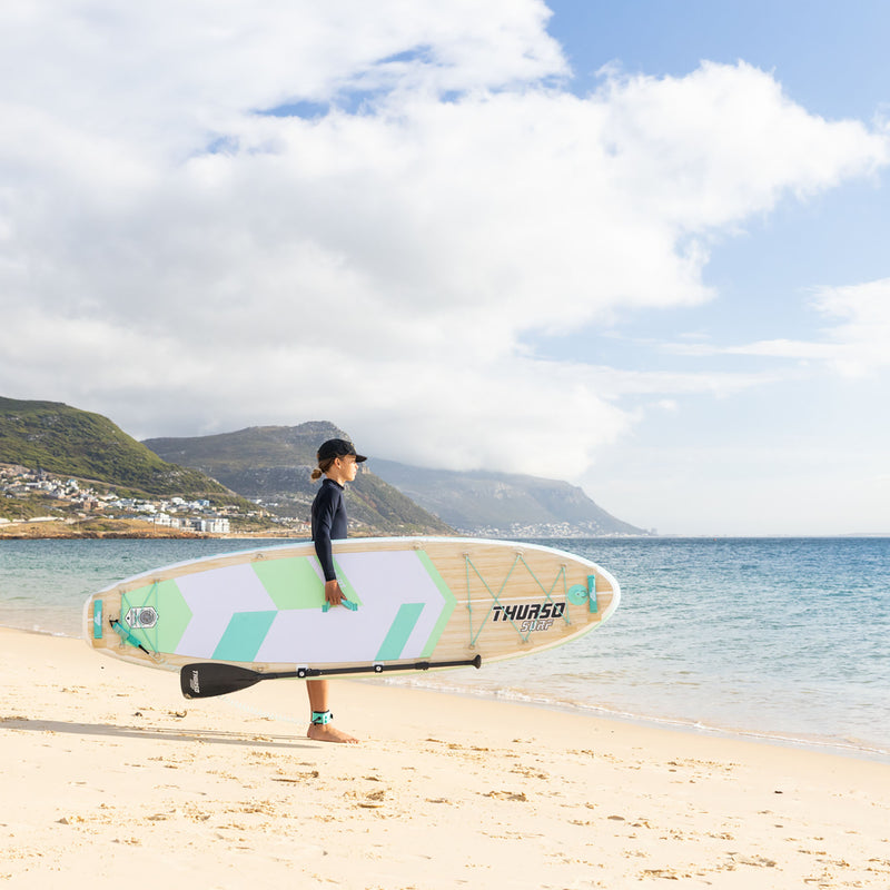 Cargue la imagen en el visor de la galería, boy carrying a sup standing at the beach
